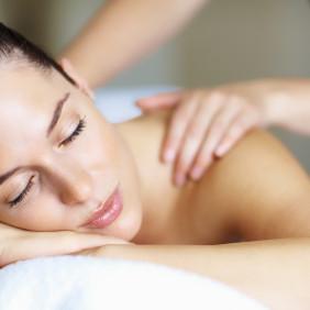 Closeup of relaxed woman receiving back massage at spa